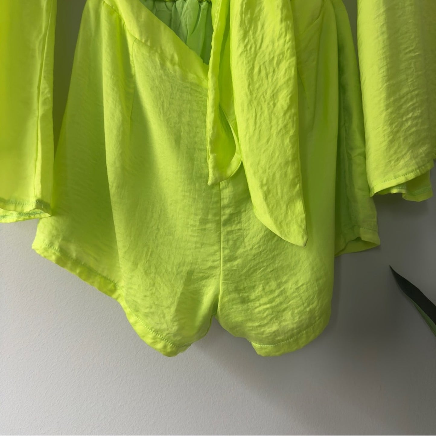 SNDYS x Revolve Pluto Romper in Neon Green Bright flared long sleeves cut out 4