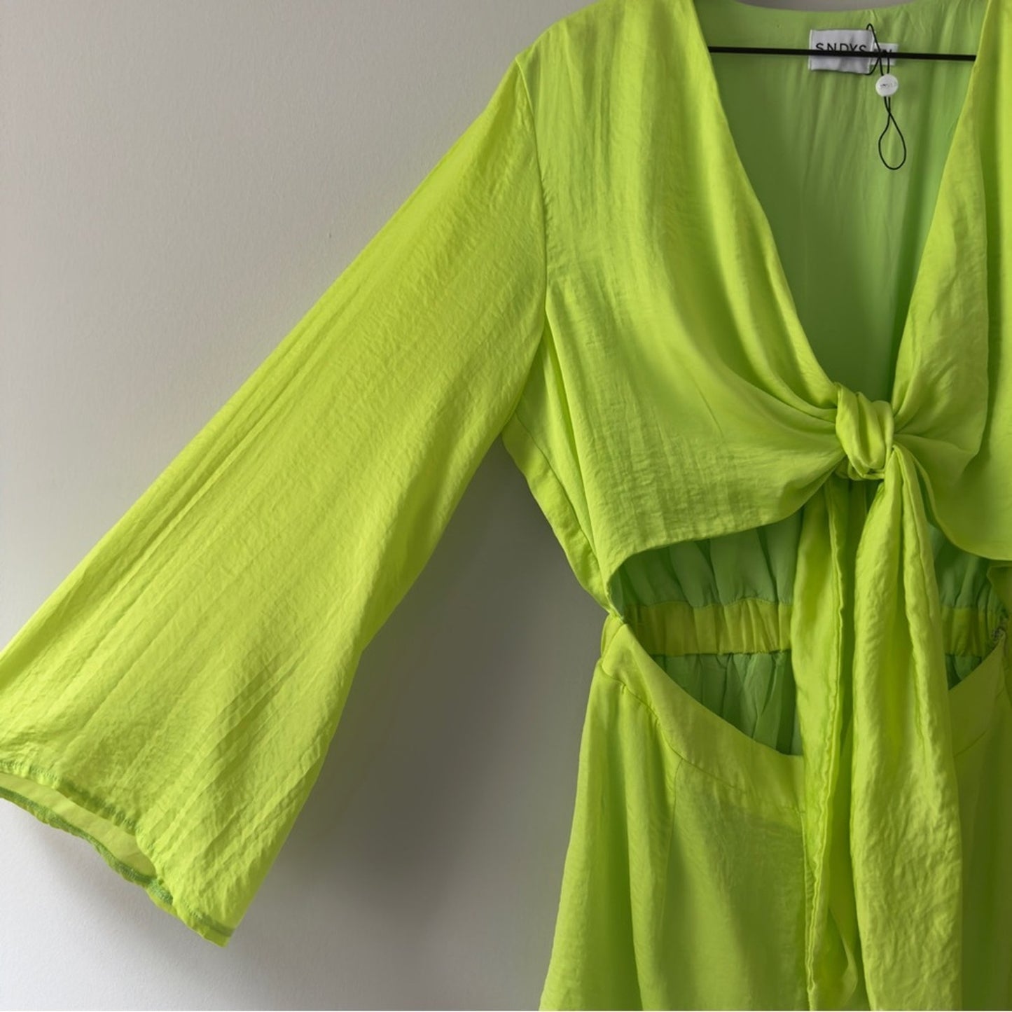SNDYS x Revolve Pluto Romper in Neon Green Bright flared long sleeves cut out 4