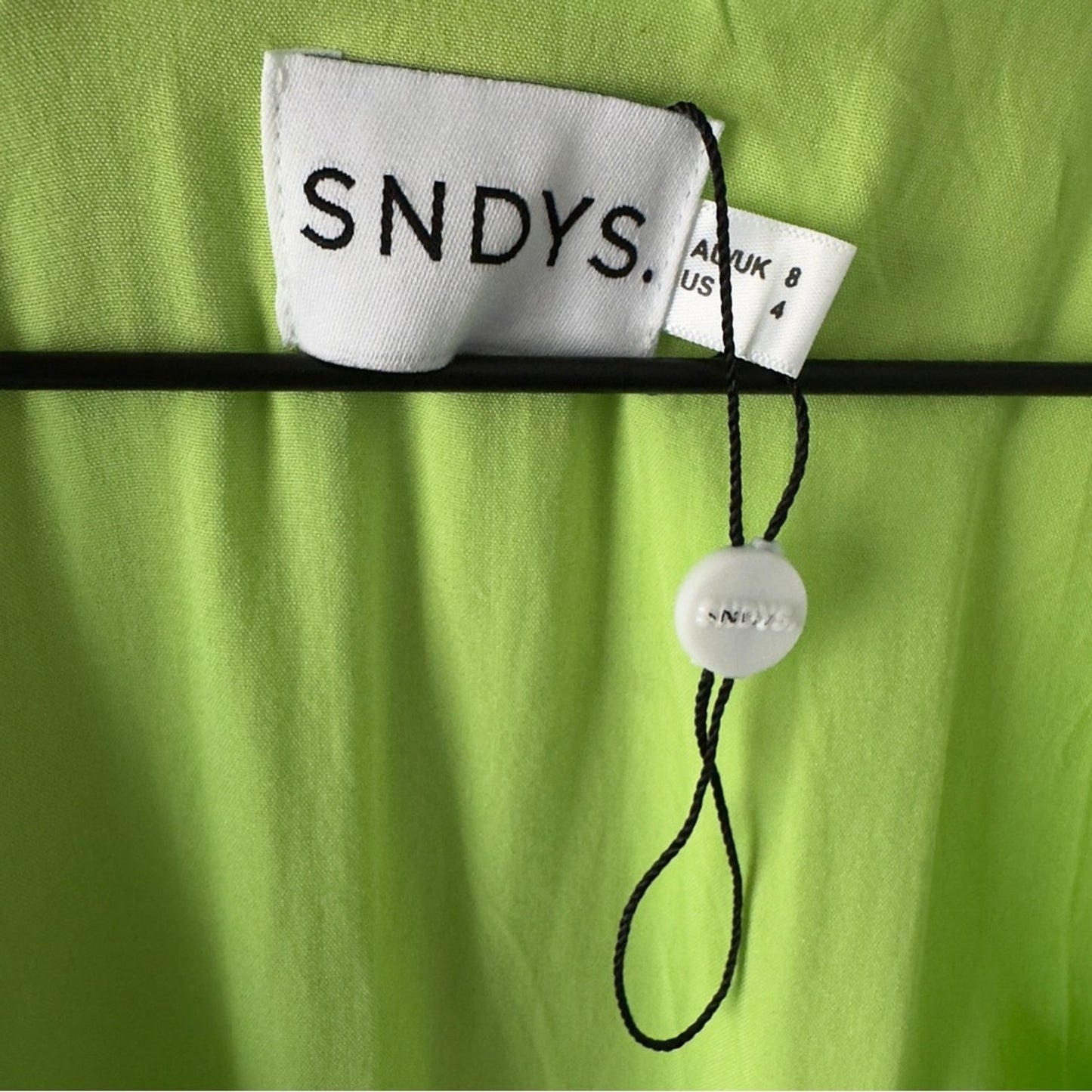 SNDYS x Revolve Pluto Romper in Neon Green Bright flared long sleeves cut out 4